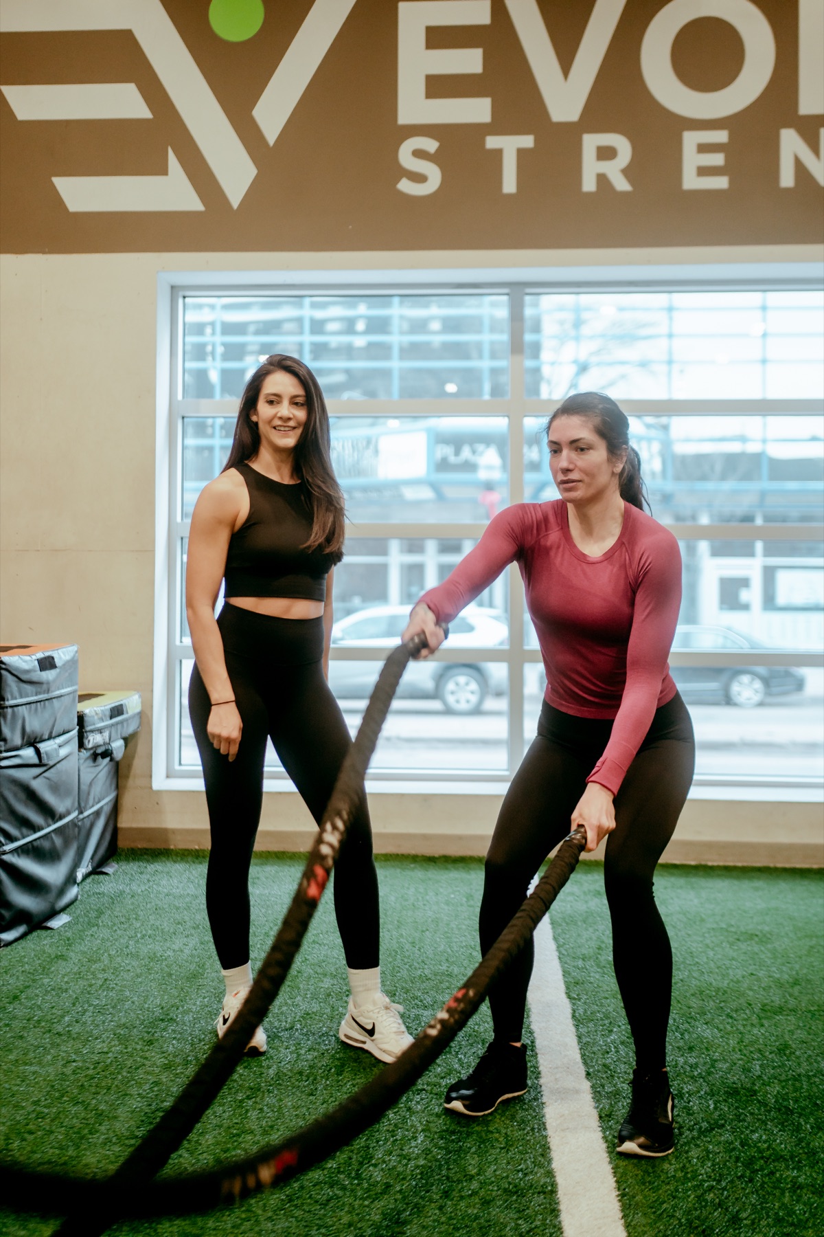 Personal training session under the Evolve Strength sign in downtown Edmonton