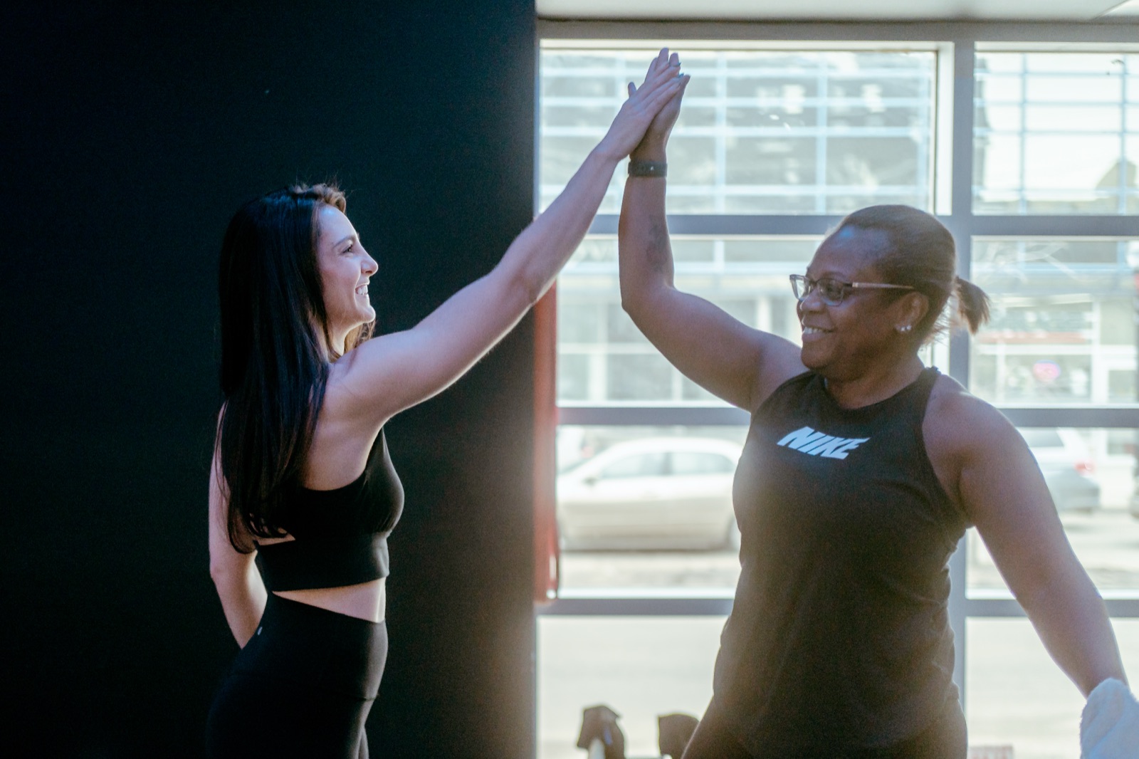 Members high-fiving after a Fit Training class